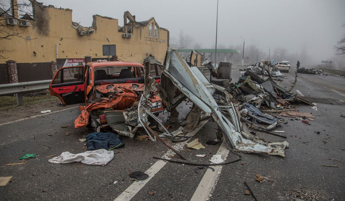Squashed civilian cars are seen on a street of Bucha